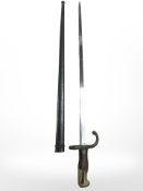 A French Gras Epee bayonet Modele 1874 bayonet with wood grips and steel scabbard, manufactured St.