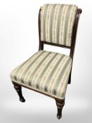 A late Victorian mahogany salon chair in striped classical upholstery.