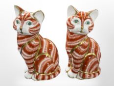 A pair of Royal Crown Derby seated cat paperweights, lacking stoppers, height 12.5cm.