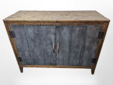 A pine and metal industrial style two door sideboard,