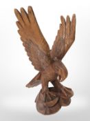 A carved wooden statue of an eagle, height 35cm.