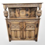 A reproduction carved oak buffet sideboard,