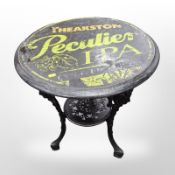 A Britannia style cast iron pub table with Theakston Peculier IPA top,