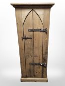 A pine single door cupboard with shelved interior,