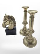 A brass horse head bookend and a pair of candlesticks, height 23 cm.