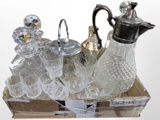 A group of crystal drinking glasses, two decanters, claret jug with plated lid, biscuit barrel,
