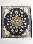 A small Iranian rug on indigo ground, 50 cm x 46 cm.