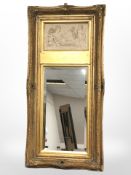A reproduction gilt mirror with inset plaster panels depicting a classical scene,