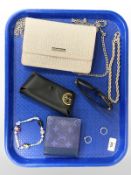 A lady's Carvela evening bag, a gold plated chain, costume bracelet, a white metal dress ring,