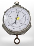 A metal cased scale and two magnum sized wine bottles.