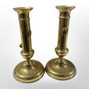 A pair of brass ejector candlesticks, height 19.5 cm.