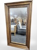 A large contemporary hardwood floor standing mirror,