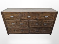 A seven drawer sideboard with metal industrial style handles,