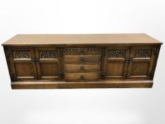 An Old Charm carved oak low sideboard,