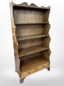 A reproduction mahogany waterfall open bookcase,
