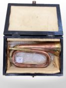 A copper and brass military bugle with two mouthpieces,