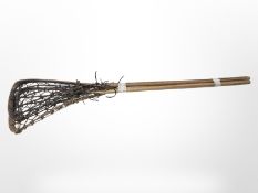 Two vintage lacrosse sticks.