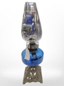 An oil lamp with gilt metal base and blue glass reservoir, height 50 cm.