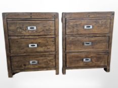 A pair of stained pine three drawer bedside chests with metal industrial style handles,