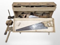 A pine joiner's tool box containing hand saws, carpentry mallets,