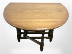 An Old Charm drop leaf dining table and four wheel back dining chairs