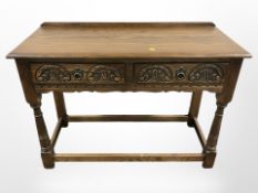 An Old Charm carved oak two drawer hall table,
