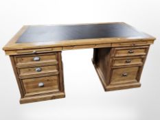 A modern stained pine twin-pedestal writing desk,