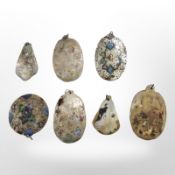 A group of polished and painted mother of pearl plaques, longest 6.5 cm.