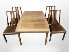 A Nathan teak extending dining table with internal leaf,