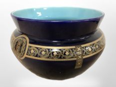 A turqoise glazed gilt pottery jardiniere, diameter 34cm.