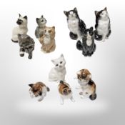 Eleven Royal Doulton figures of cats, tallest 12 cm.