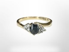 A 9ct yellow gold six stone diamond and sapphire cluster ring, size M.