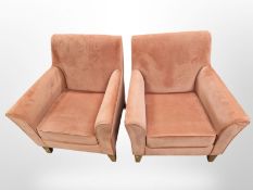 A pair of modern armchairs in peach upholstery