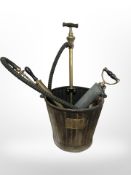 A galvanised bin containing brass air pumps.