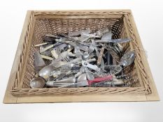 An Georgian oak two division cutlery tray and a wicker basket containing assorted flatware