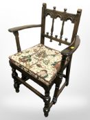 An Ercol stained elm armchair