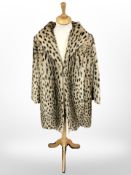 An early 20th century ocelot fur coat with mannequin