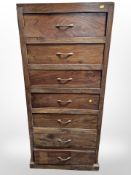 A stained hardwood seven drawer chest,