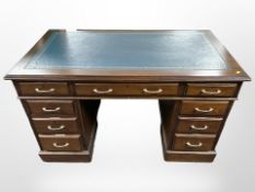 A reproduction mahogany twin pedestal nine drawer desk,