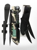 A reproduction Fairbairn-Sykes Commando fighting knife, together with two further knives in sheaths.