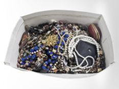A small box of assorted costume bead necklaces, Westclox travel desk timepiece, ladies purse, etc.