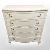 A French style cream and gilt five drawer serpentine fronted chest,