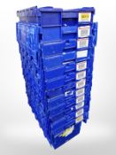 Twelve stackable plastic storage boxes with folding lids,