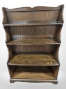 An Ercol stained elm waterfall open bookcase,