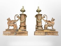 A pair of Victorian cast iron brass mounted fire dogs.