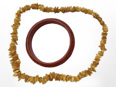 A Chinese cinnabar bangle together with butterscotch amber necklace (2)