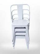 A set of four metal stacking chairs