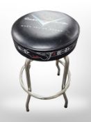 A chrome circular stool with Fender Custom Shop seat,