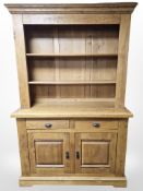 A contemporary oak dresser, 142 cm x 55 cm x 220 cm.