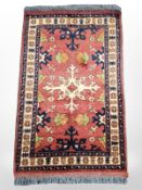 An Afghan/Caucasian rug, 140 cm x 86 cm.